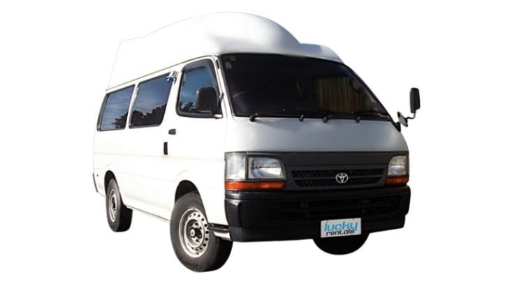A white hitop campervan with a raised roof, photographed against a white background