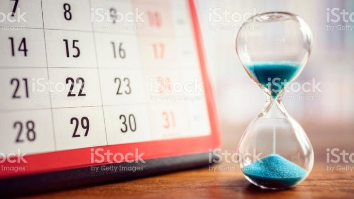 Hour glass and calendar concept for time slipping away for important appointment date, schedule and deadline